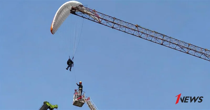 В Китае парапланерист повис на строительном кране ВИДЕО