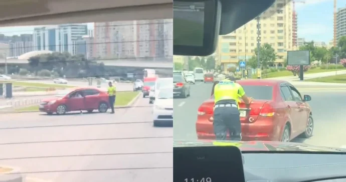 Polis nasazlıq yaranan maşını itələyib yoldan çıxarmağa kömək etdi VİDEO